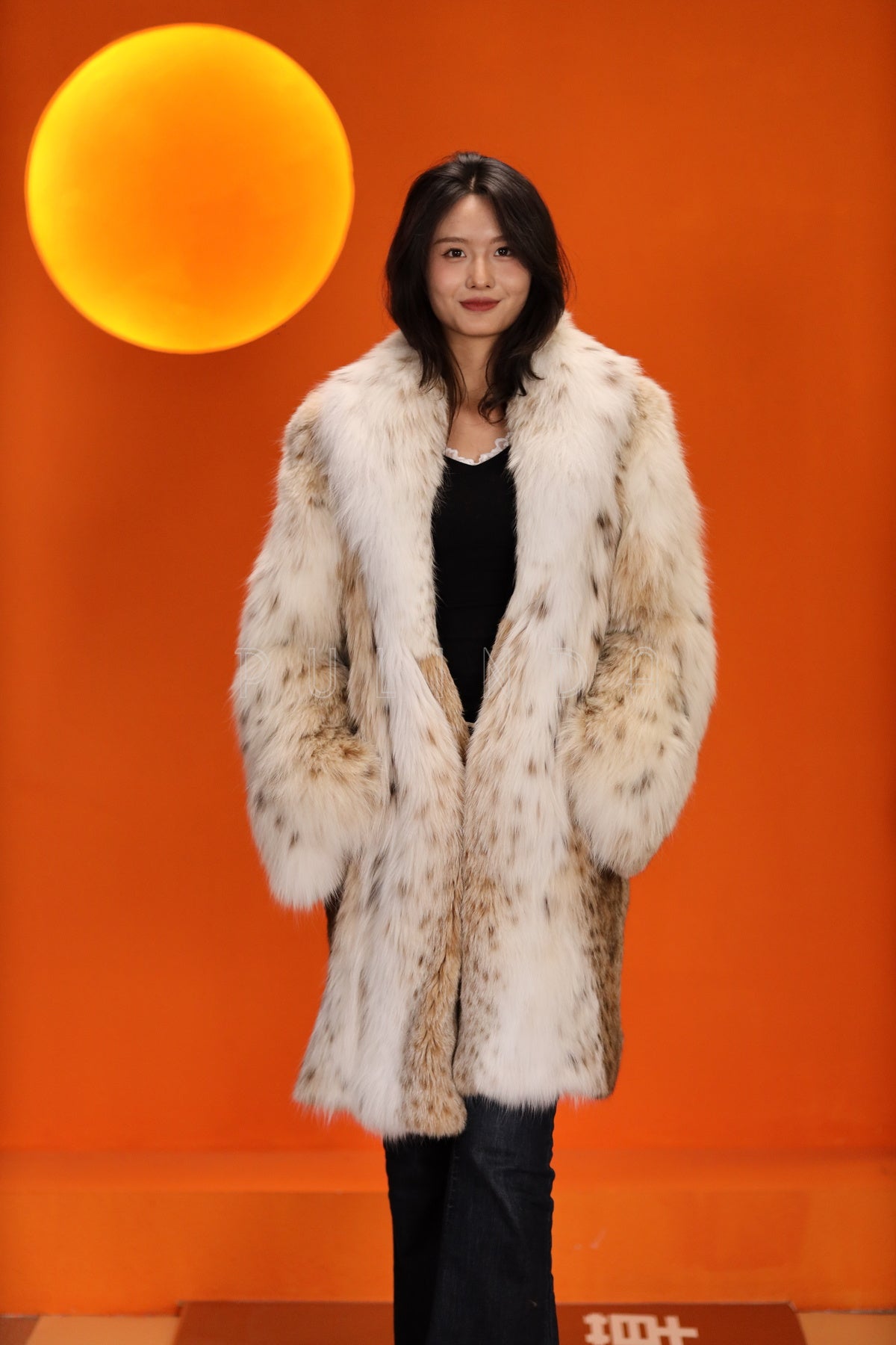 Mid-length women's natural lynx fur coat with shawl collar