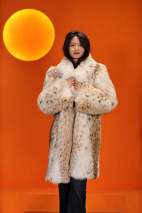 Mid-length women's natural lynx fur coat with shawl collar