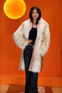 Mid-length women's natural lynx fur coat with shawl collar