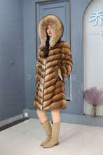 Load image into Gallery viewer, Full length muskrat fur hooded coat with racoon trim
