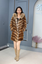 Load image into Gallery viewer, Full length muskrat fur hooded coat with racoon trim
