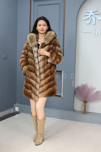 Full length muskrat fur hooded coat with racoon trim