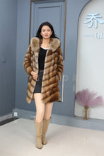 Load image into Gallery viewer, Full length muskrat fur hooded coat with racoon trim
