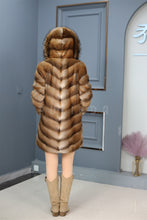 Load image into Gallery viewer, Full length muskrat fur hooded coat with racoon trim
